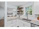 Beautiful kitchen boasts granite countertops, white cabinets, and floating shelves at 3308 Selwyn Farms Ln # 5, Charlotte, NC 28209
