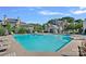 Community pool area with ample seating, mature trees, and well-maintained pool house for residents' enjoyment at 3308 Selwyn Farms Ln # 5, Charlotte, NC 28209