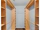 Spacious walk-in closet featuring custom built-in shelving and a coat rack for storage and organization at 3308 Selwyn Farms Ln # 5, Charlotte, NC 28209