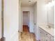 Bathroom with a tile floor, white cabinets, and a doorway to the bedroom at 4009 Lawnview Dr, Charlotte, NC 28269