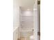 All white bathroom with a shower-tub combo, toilet, and a white cabinet at 4009 Lawnview Dr, Charlotte, NC 28269