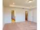 Spacious bedroom features plush carpeting, recessed lighting, and multiple doorways at 4009 Lawnview Dr, Charlotte, NC 28269