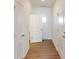 Bright hallway featuring hardwood floors and white trim throughout at 4009 Lawnview Dr, Charlotte, NC 28269