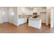 Open concept kitchen and dining area with hardwood floors and an island at 4009 Lawnview Dr, Charlotte, NC 28269