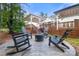 Charming backyard with a fire pit area surrounded by rocking chairs, ideal for outdoor enjoyment at 4189 Island Fox Ln, Denver, NC 28037