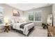 Bright bedroom featuring neutral tones, natural light from windows, a cozy bed, and stylish decor at 4189 Island Fox Ln, Denver, NC 28037