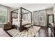 Spacious bedroom with a canopy bed, plush rug, and plenty of natural light at 4189 Island Fox Ln, Denver, NC 28037