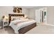 Stylish bedroom with a rustic wood bed frame, decorative headboard, and ample natural light at 4189 Island Fox Ln, Denver, NC 28037