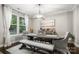 Dining room with a large window, modern light fixture, and seating for six at 4189 Island Fox Ln, Denver, NC 28037