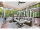 Inviting screened porch with stylish seating, ceiling fan, and a view of the backyard entertainment area at 4189 Island Fox Ln, Denver, NC 28037