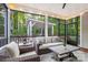Relaxing screened-in porch with wicker furniture and string lights, overlooking a beautiful backyard at 4189 Island Fox Ln, Denver, NC 28037