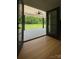 View of green backyard and open porch through French doors at 420 Sloop St, China Grove, NC 28023
