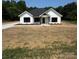 Charming, modern farmhouse with board and batten siding, a black roof and freshly laid driveway at 420 Sloop St, China Grove, NC 28023