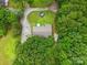 An aerial view of a quaint property surrounded by lush greenery with a circular driveway and well-maintained lawn at 4230 Train Chaser Pl, Indian Land, SC 29707