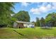 Spacious backyard featuring a deck, playground, trampoline, and lush green grass, perfect for outdoor activities at 4230 Train Chaser Pl, Indian Land, SC 29707
