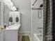 Modern bathroom features double sinks, a large mirror, tiled walls, and a shower-tub combination at 4230 Train Chaser Pl, Indian Land, SC 29707