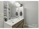 Stylish bathroom featuring double sinks, a decorative mirror, and modern fixtures at 4230 Train Chaser Pl, Indian Land, SC 29707