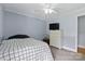 Cozy blue bedroom featuring two-tone paint, carpet, a ceiling fan, and a dresser with television at 4230 Train Chaser Pl, Indian Land, SC 29707