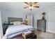 Comfortable bedroom with a ceiling fan, soft lighting, carpet, and a gray dresser at 4230 Train Chaser Pl, Indian Land, SC 29707