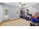 Bedroom with a back door to the yard and two sunny windows at 4230 Train Chaser Pl, Indian Land, SC 29707