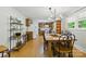 Open dining area with a rustic table, chandelier lighting, and views into the adjacent kitchen at 4230 Train Chaser Pl, Indian Land, SC 29707