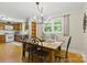 Dining room with hardwood floors, chandelier, and large windows offering views of the surrounding landscape at 4230 Train Chaser Pl, Indian Land, SC 29707
