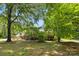 Exterior rear view of home featuring a wooden ramp and deck overlooking a lush backyard at 4230 Train Chaser Pl, Indian Land, SC 29707