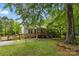 Charming one-story home with ramp access, lush greenery, and a welcoming front porch at 4230 Train Chaser Pl, Indian Land, SC 29707