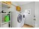 A laundry room featuring a washer and dryer, along with upper shelving and a window at 4230 Train Chaser Pl, Indian Land, SC 29707