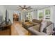 Spacious living room showcasing hardwood floors, a ceiling fan, and views into the dining area at 4230 Train Chaser Pl, Indian Land, SC 29707