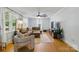 Comfortable living room with hardwood floors, neutral decor, and large windows for natural light at 4230 Train Chaser Pl, Indian Land, SC 29707