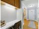 Bright office area with built-in desk and storage, leading to an entryway with hardwood floors at 4230 Train Chaser Pl, Indian Land, SC 29707