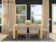 Inviting dining area featuring large windows, a modern table, and stylish decor at 4262 Skyboat Cir, Fort Mill, SC 29715