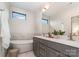 Elegant bathroom featuring a soaking tub, double vanity, and marble tile accents at 428 E 33Rd St, Charlotte, NC 28205