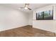 Neutral bedroom with wood floors, ceiling fan, and large window with view at 428 E 33Rd St, Charlotte, NC 28205