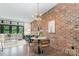 Stylish dining area with modern lighting, brick accent wall, and open concept living at 428 E 33Rd St, Charlotte, NC 28205