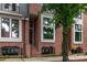 Charming red brick townhome with black-trimmed windows and landscaped front entrance at 428 E 33Rd St, Charlotte, NC 28205