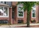 Charming red brick townhome with black-trimmed windows and landscaped front entrance at 428 E 33Rd St, Charlotte, NC 28205
