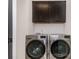 Convenient laundry room featuring front-loading washer and dryer and modern cabinets above at 428 E 33Rd St, Charlotte, NC 28205