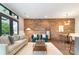 Spacious living room with exposed brick wall, modern furnishings, and bright natural light at 428 E 33Rd St, Charlotte, NC 28205