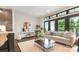 Bright living room with hardwood floors, modern decor, and an open layout to the kitchen at 428 E 33Rd St, Charlotte, NC 28205