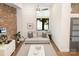 Cozy living room with a brick wall, a light gray sofa, and lots of natural light at 428 E 33Rd St, Charlotte, NC 28205