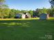 This large backyard includes a shed and a wooden deck for outdoor enjoyment at 4317 Waxhaw Indian Trail Rd, Indian Trail, NC 28079