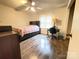 Bedroom with wood-look floors, ample natural light, and space for a bed and desk at 4317 Waxhaw Indian Trail Rd, Indian Trail, NC 28079