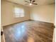 Clean bedroom with hardwood floors, ceiling fan, and natural light from window at 4317 Waxhaw Indian Trail Rd, Indian Trail, NC 28079