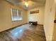 This cozy bedroom has hardwood floors, neutral paint and a ceiling fan for ideal comfort at 4317 Waxhaw Indian Trail Rd, Indian Trail, NC 28079