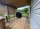 This covered wooden deck offers ample space and a grill for outdoor entertaining at 4317 Waxhaw Indian Trail Rd, Indian Trail, NC 28079