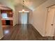 Dining space with wood-look floors, modern lighting, and kitchen access at 4317 Waxhaw Indian Trail Rd, Indian Trail, NC 28079