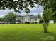 Inviting single-story home boasting a sprawling front yard and manicured landscaping at 4317 Waxhaw Indian Trail Rd, Indian Trail, NC 28079