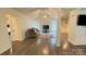 Open-concept living room with vaulted ceiling, hardwood floors, and a cozy seating arrangement at 4317 Waxhaw Indian Trail Rd, Indian Trail, NC 28079